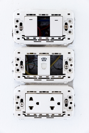 Home standard electrical switch and plug on wallの写真素材