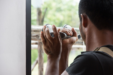 glazier work installing glass in site constructionの写真素材