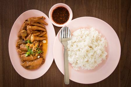 Thai food rice and stewed chicken wings, chicken foot on pink dishの写真素材