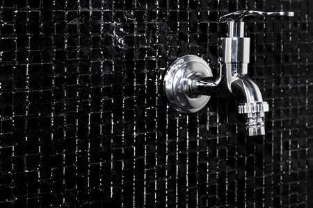 Modern design home bathroom Faucet on black tileの写真素材