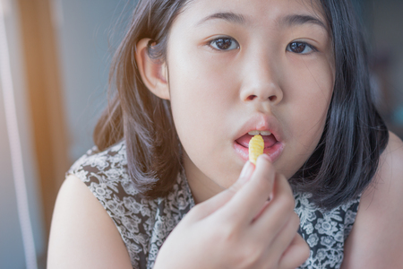 girl action portrait eating French friesの写真素材