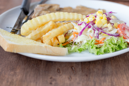 Grilled steak salad French fries on dish whiteの写真素材