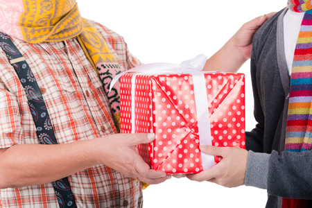 Father gave a gift to his son on Christmas Eve.Isolated on white background.の写真素材