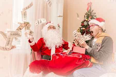 Santa claus gives gift to man Christmas eve ,Christmas conceptの写真素材