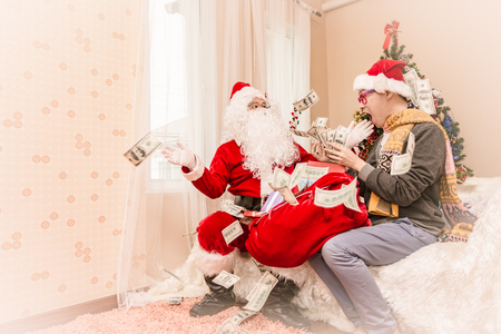 Santa claus gives gift to man Christmas eve ,Christmas conceptの写真素材