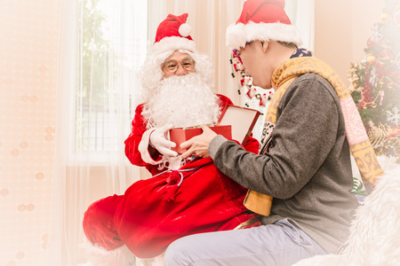 Santa claus gives gift to man Christmas eve ,Christmas conceptの写真素材