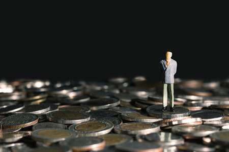 close model business men Gesture stand on coinsの写真素材