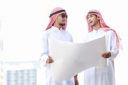 Arab business man looking working on plan peper in the cityの写真素材