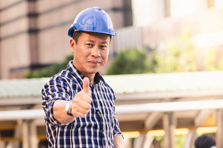 Engineers man working on plan building construction in cityの写真素材