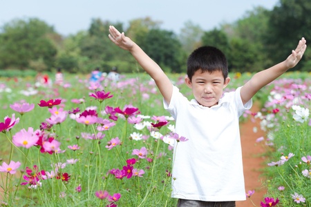 Portrait beautiful happy young boy enjoying beautiful gardenの写真素材