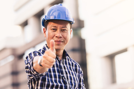 Engineers man working on plan building construction in cityの写真素材