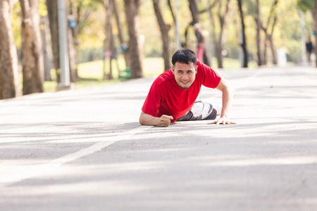 Asian young sport man ankle injury from jogging