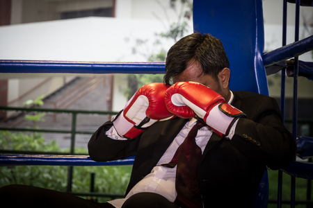 Asian businessman with boxing gloves. Concept of relentless struggle and successの写真素材
