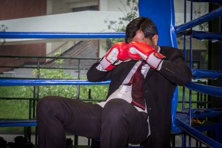 Asian businessman with boxing gloves. Concept of relentless struggle and successの写真素材