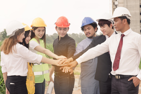 Asian engineer concept Teamwork of building construction. Project contractor reviewing plan work in construction site.の写真素材