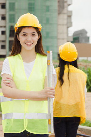 Two Asian woman Engineers working on building constructionの写真素材