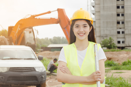 Engineers asian two woman working on plan building construction with paper in site