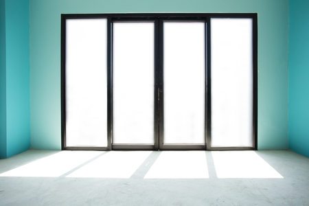 An empty interior of a blue house with black door frames under constructionの写真素材