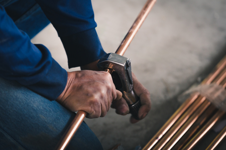 Industry system men worker cut joint with tool of copper pipe air conditionerの写真素材