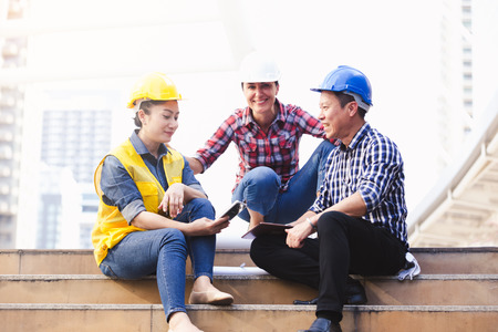 Engineers man and woman working on plan building construction in city