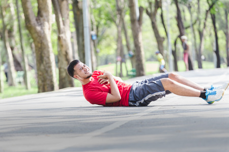 Asian cardiac arrest running young man heart attack in park.Severe heartache