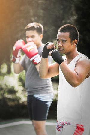 Asian young men with personal trainer boxing friend, Boxing glovesの写真素材