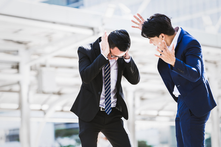 Asian businessman angry worker background city. Business conceptの写真素材