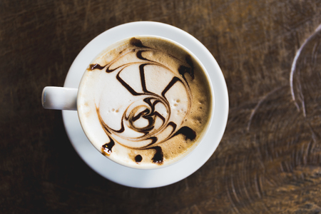 coffee art in white cup on table wood coffee shop cafeの写真素材