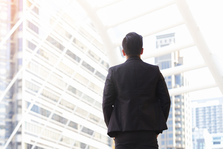 Back view asian business men of successful looking cityの写真素材