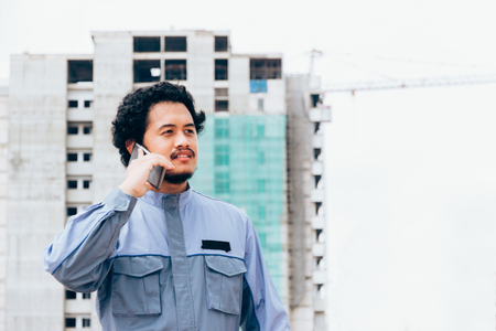 Asian engineer concept Teamwork of building construction. Project contractor reviewing plan work in construction site.の写真素材
