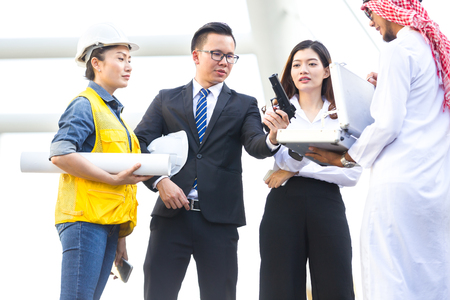 Business men wearing suit holding machine gun in cityの写真素材