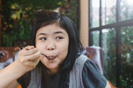 Portrait asian young girl in restaurant shopの写真素材