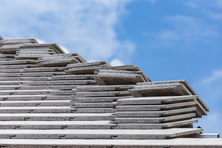 Tile roof concrete gray color under construction with stacks on roofの写真素材