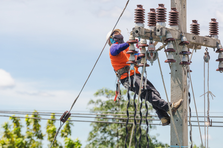 NAKHONRATCHASIMA, THAILAND - SEPTEMBER 1, 2018:Asian men engineering working on high voltage workfield at countrysideのeditorial素材