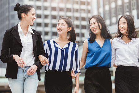 Asian lifestyle businesswoman best friends smiling and having fun walking at the cityの写真素材
