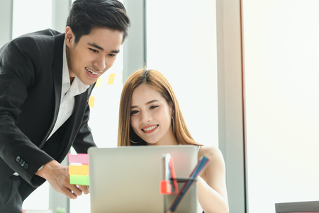 Asian couple working in office,Business people team work plan on jobの写真素材