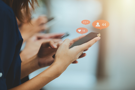 Social media,Asian women play phone concept with smartphoneの写真素材