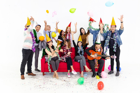 Cheerful young people sitting on red sofa isolated white background,People group party concept