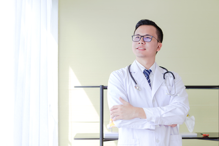 Portrait Asian Doctor standing in medical officeの写真素材