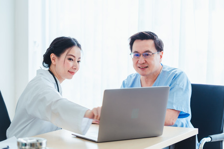 Old Patient men Talking with Medical Doctor women in clinic officeの写真素材