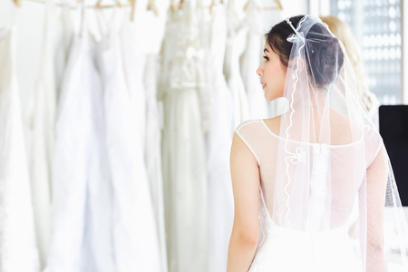 Asian portrait of cute lady smiling happy wearing wedding dressの写真素材