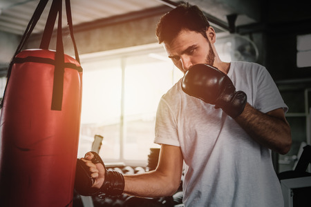 Portrait sporty men with the back boxing gloves training at the gym