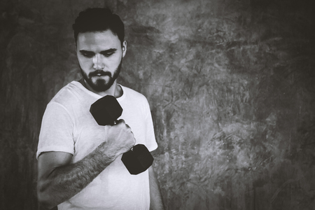 Closeup men healthy holding dumbbell workout and building body at gym fitnessの写真素材