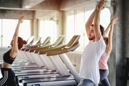 Young woman and men training lifestyle healthy body workout in gym, Sports style yoga concept