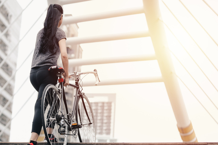 Lifestyle sport woman and health riding bike in city backgroundの写真素材