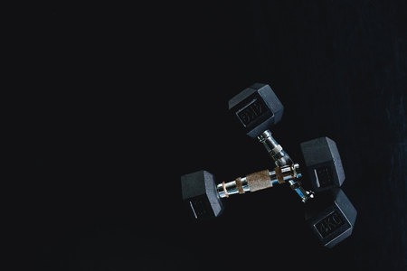 Background view back and white equipment dumbbells on floor in the gym sport centerの写真素材