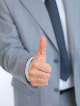 Portrait of handsome businessman showing thumb up hand signの写真素材