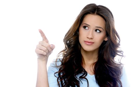 Portrait of beautiful brunette woman pointing at copyspaceの写真素材