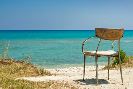 Lonely old chair on beachの写真素材