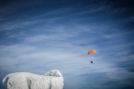Snow sculpture with paraglider in the backgroundの写真素材
